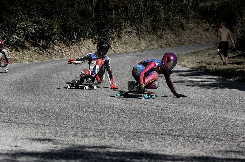 two skaters on a downhill